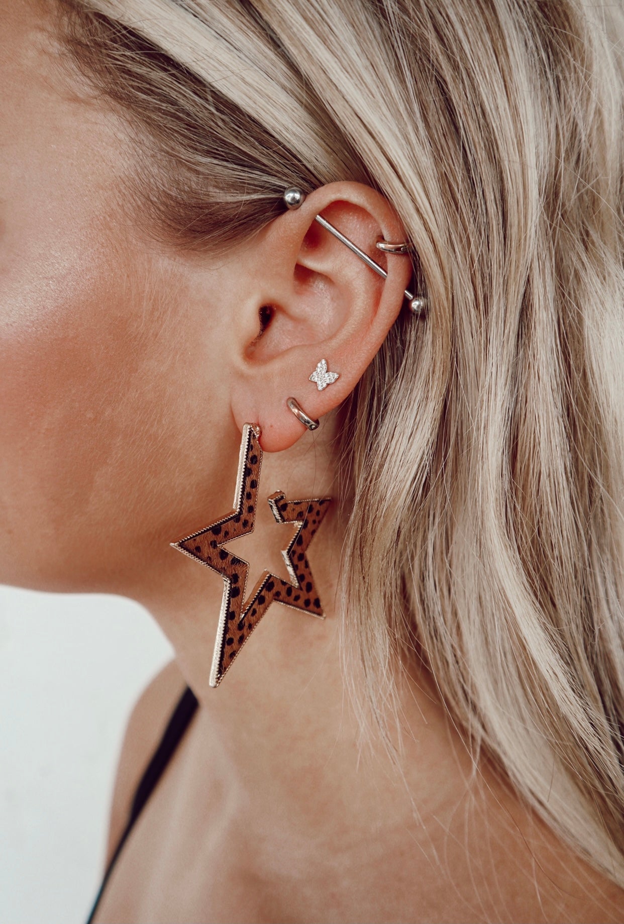 open star cow print earrings - tan