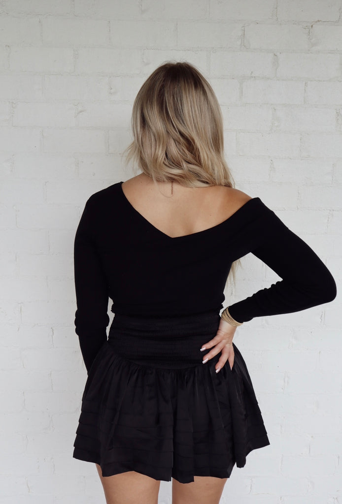 black asymmetrical knit top